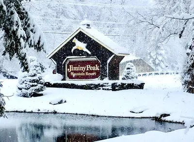 a sign in the snow next to a pond at Gorgeous 1st FL Mtn View Jiminy Suite Sleeps 4 Ski On Off in Hancock