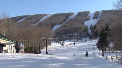 a group of people skiing down a snow covered slope at Gorgeous 1st FL Mtn View Jiminy Suite Sleeps 4 Ski On Off in Hancock