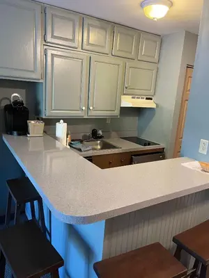 a kitchen with white cabinets and a counter top at Gorgeous 1st FL Mtn View Jiminy Suite Sleeps 4 Ski On Off in Hancock