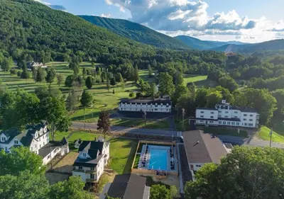 an aerial view of a mansion with a swimming pool at Wylder Windham in Windham