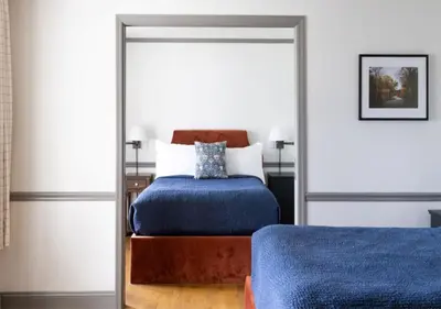 a bedroom with a bed and a mirror at Wylder Windham in Windham