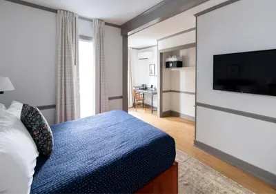 a hotel room with a bed and a flat screen tv at Wylder Windham in Windham