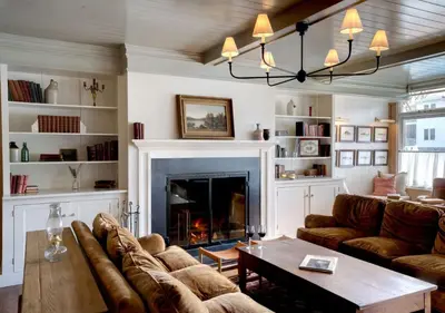 a living room with a couch and a fireplace at Wylder Windham in Windham