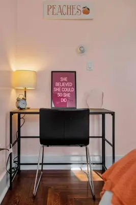 a black chair in a room with a desk at Peachy Paradise in East Rock Near DT/Yale in New Haven