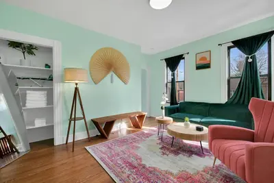 a living room with a green couch and a table at Green N' Groovy in the Heart of East Rock Near DT, Yale in New Haven