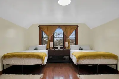 two beds in a white room with a window at Golden Gem in Heart of East Rock Quiet 3BR Near DT and Yale in New Haven