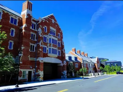 a red brick building with a tower on a street at Golden Gem in Heart of East Rock Quiet 3BR Near DT and Yale in New Haven