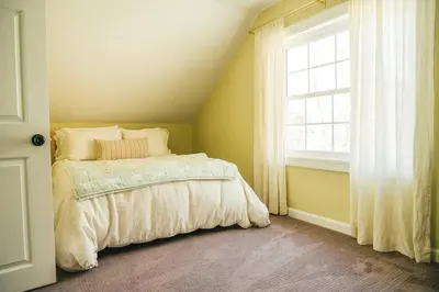 a bedroom with a bed and a window at Cozy Cottage, Hot Tub, Fire Pit, 15min to Hudson and hiking in Catskill