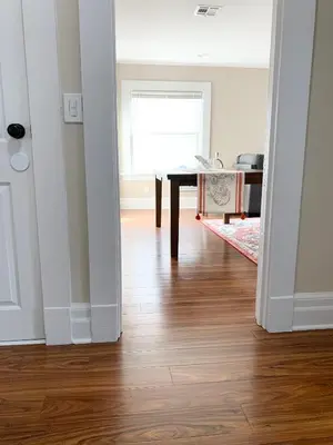 a living room with a table and a wooden floor at Newly renovated 4 bedroom apartment near downtown. in Montclair