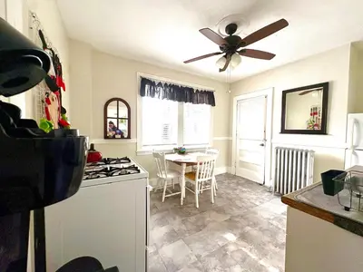 a kitchen with a ceiling fan and a table at The Jazz Suite B1 in Hartford