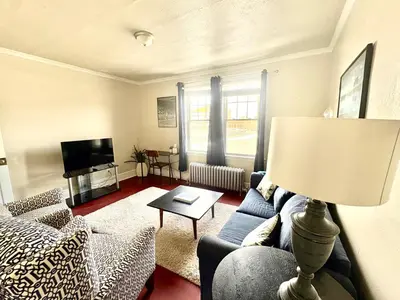a living room with a couch and a table at The Jazz Suite B1 in Hartford