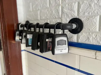 a row of cell phones hanging on a wall at The Jazz Suite B1 in Hartford
