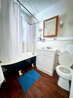 a bathroom with a tub and a toilet and a sink at The Jazz Suite B1 in Hartford