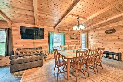 a dining room with a table and chairs at Otego Home with Hot Tub Near All Star Village! in Oneonta