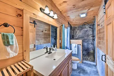 a bathroom with a sink and a toilet at Otego Home with Hot Tub Near All Star Village! in Oneonta