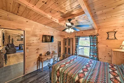 a bedroom with a bed and a ceiling fan at Otego Home with Hot Tub Near All Star Village! in Oneonta