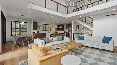 a living room with two couches and a table at Forget-Me-Not by AvantStay Bold Lakefront Escape in Monterey