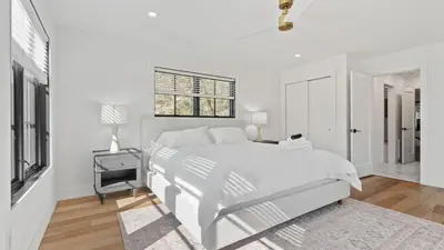 a white bedroom with a bed and a window at Forget-Me-Not by AvantStay Bold Lakefront Escape in Monterey