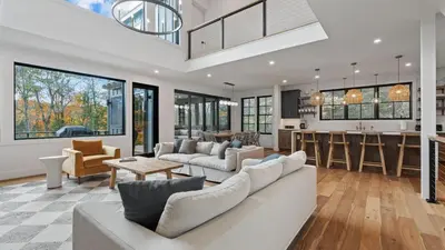 a living room with a couch and a kitchen at Forget-Me-Not by AvantStay Bold Lakefront Escape in Monterey