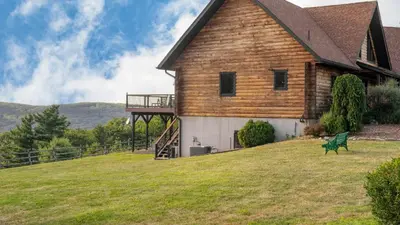 a house on a hill with a green bench in front of it at Chester by AvantStay Amazing Views Secluded Home A True City Escape in Austerlitz