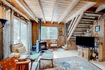 a living room with a fireplace and a television at Mowing Way Retreat in Wilmington
