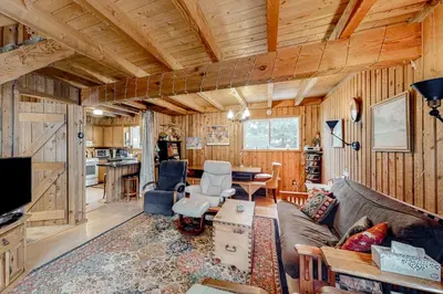 a living room with a couch and a table at Mowing Way Retreat in Wilmington