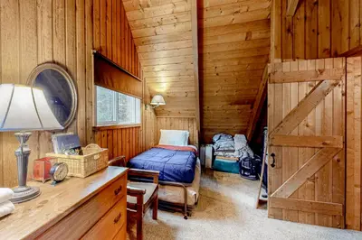 a bedroom with a bed and a wooden wall at Mowing Way Retreat in Wilmington