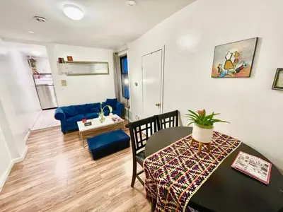 a living room with a table and a dining room at Bedroom 10 mins to Times Square! and is first floor in Queens