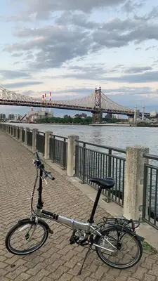 a bike parked on a sidewalk next to a bridge at Bedroom 10 mins to Times Square! and is first floor in Queens