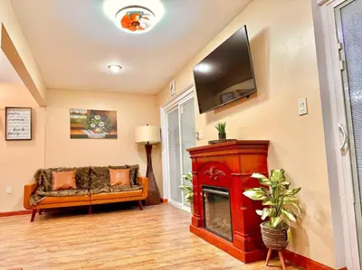 a living room with a fireplace and a tv at Chic Chalet River Views & Access in Montague