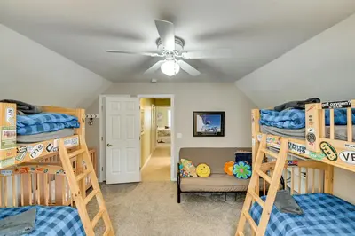 a room with three bunk beds and a ceiling fan at 5 Mi to Mt Snow West Dover Getaway with Hot Tub in Brattleboro