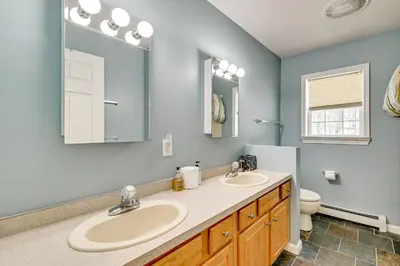 a bathroom with two sinks and a toilet at 5 Mi to Mt Snow West Dover Getaway with Hot Tub in Brattleboro