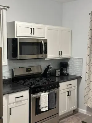 a kitchen with a stove and a microwave at Newly 5 Star 3 Beds 1 Bath ideal Short term rental in Schenectady
