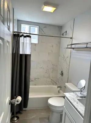 a bathroom with a tub and a toilet and a sink at Newly 5 Star 3 Beds 1 Bath ideal Short term rental in Schenectady