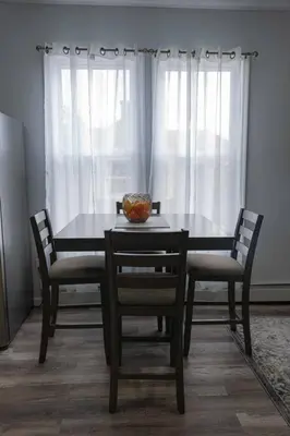 a dining room table with chairs and a bowl on it at Modern, Luxury 2 Bedroom Apt in Prime Location in Schenectady