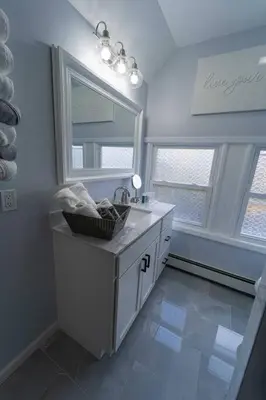 a bathroom with a sink and a mirror at Modern, Luxury 2 Bedroom Apt in Prime Location in Schenectady