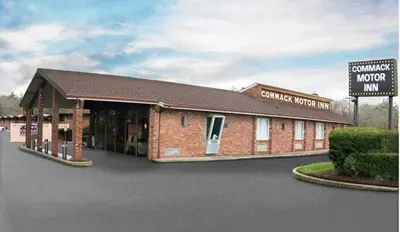 a rendering of a building with a sign in front at Commack Inn in Commack