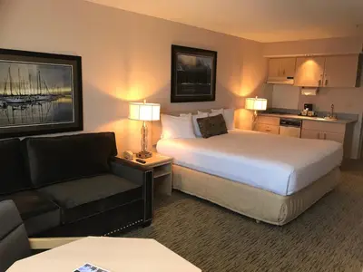 a hotel room with a large bed and a couch at Commack Inn in Commack