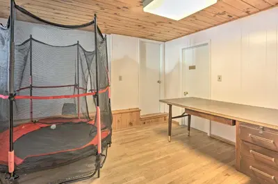 a room with a bed and a desk and a table at Large Greeley House with 2 Game Rooms and Yard! in Lackawaxen