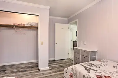 a bedroom with a bed and a mirror at Large Greeley House with 2 Game Rooms and Yard! in Lackawaxen