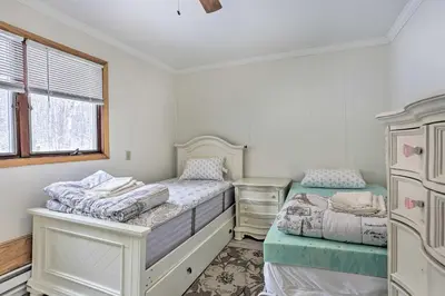 a bedroom with two beds and a window at Large Greeley House with 2 Game Rooms and Yard! in Lackawaxen