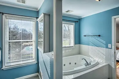 a blue bathroom with a tub and a window at Pet-Friendly Beacon Area Vacation Rental 6 Acres in Lagrangeville