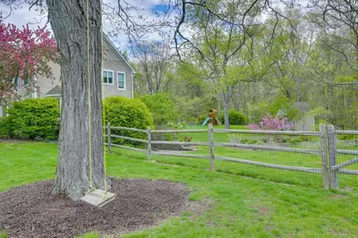 a fence with a tree in front of a house at Pet-Friendly Beacon Area Vacation Rental 6 Acres in Lagrangeville