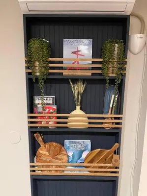 a book shelf with vases and books on it at Catskill MNTN Escape 5 BR 3 bath Villa Hot Tub Fire Pit Best Group Stay in Prattsville