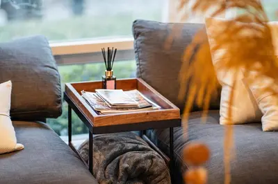 a wooden tray on a table on a couch at Catskill MNTN Escape 5 BR 3 bath Villa Hot Tub Fire Pit Best Group Stay in Prattsville