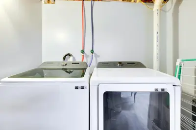 a kitchen with a sink and a tv at 8 Mi to Tobyhanna State Park Poconos Home! in Mushroom Farms