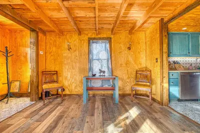 a dining room with a table and two chairs at Catskills Cottage with Deck, 7 Mi to Hunter Mtn in Elka Park