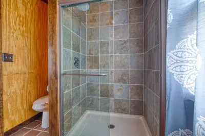 a shower with a glass door in a bathroom at Catskills Cottage with Deck, 7 Mi to Hunter Mtn in Elka Park
