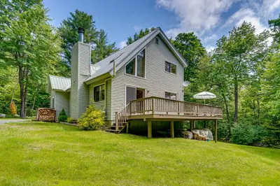 a house with a deck on a lawn at Relaxing Home Mins from Mt Snow, Hiking, and Lakes in Dover