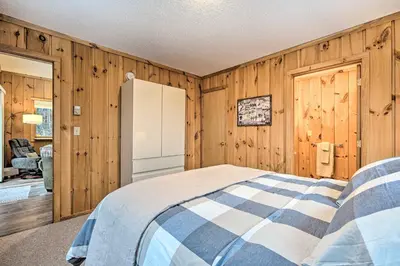 a bedroom with wooden walls and a bed in a room at Relaxing Home Mins from Mt Snow, Hiking, and Lakes in Dover